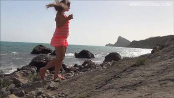 Nadia poops by the ocean